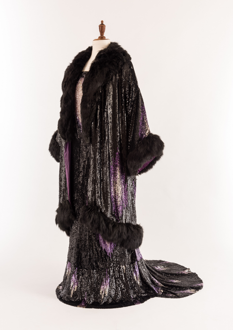 Evening dress and coat, black and purple sequins with fur trim, worn by Queen Mary about 1930